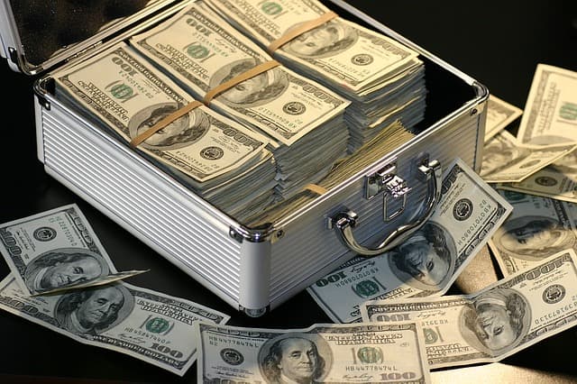 A metal case filled with bundled hundred dollar bills